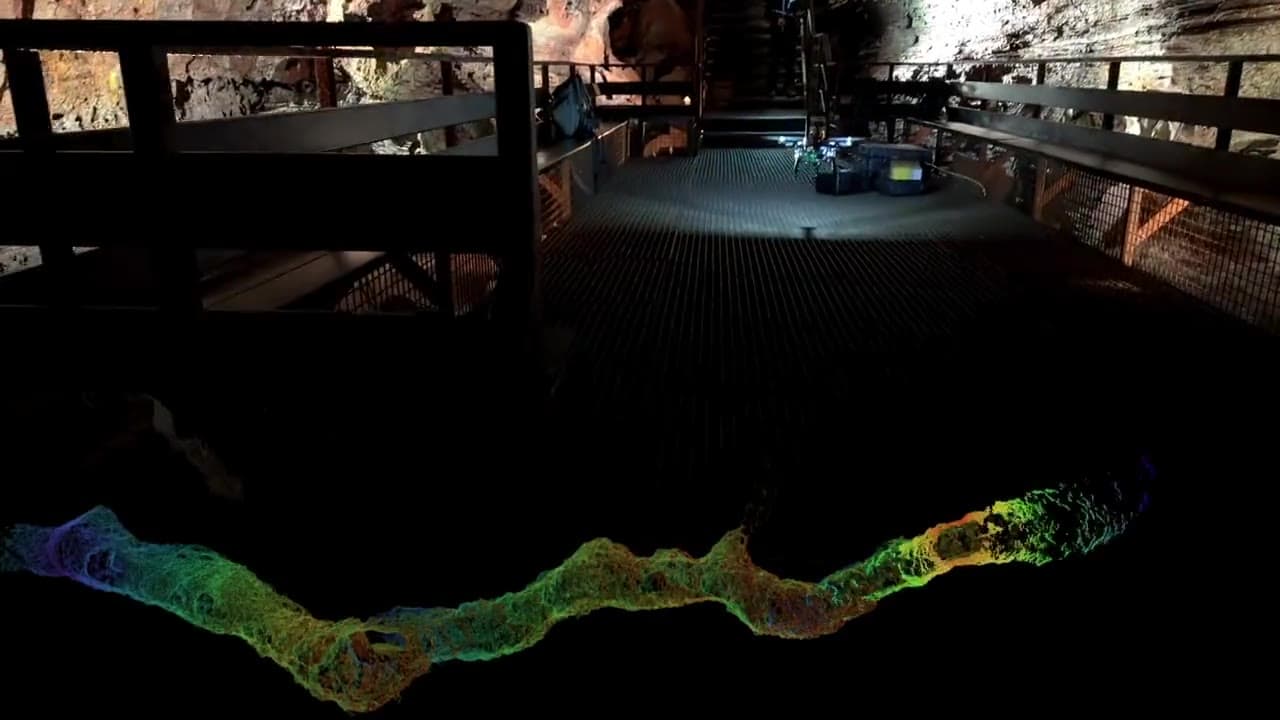 The mission drone returning to its platform inside the Iceland lava tube, the 3D map it built overlaid below
